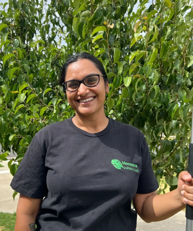 Karishma from Monstera Garden Care in front of a tree